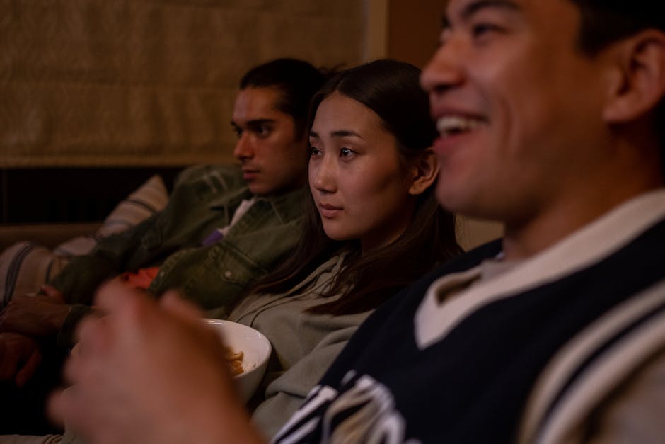 People watching a movie together in a cozy room